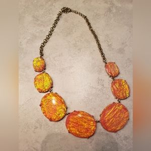 Beautiful short gold necklace with cora sun burst beads that sparkle and "glow"